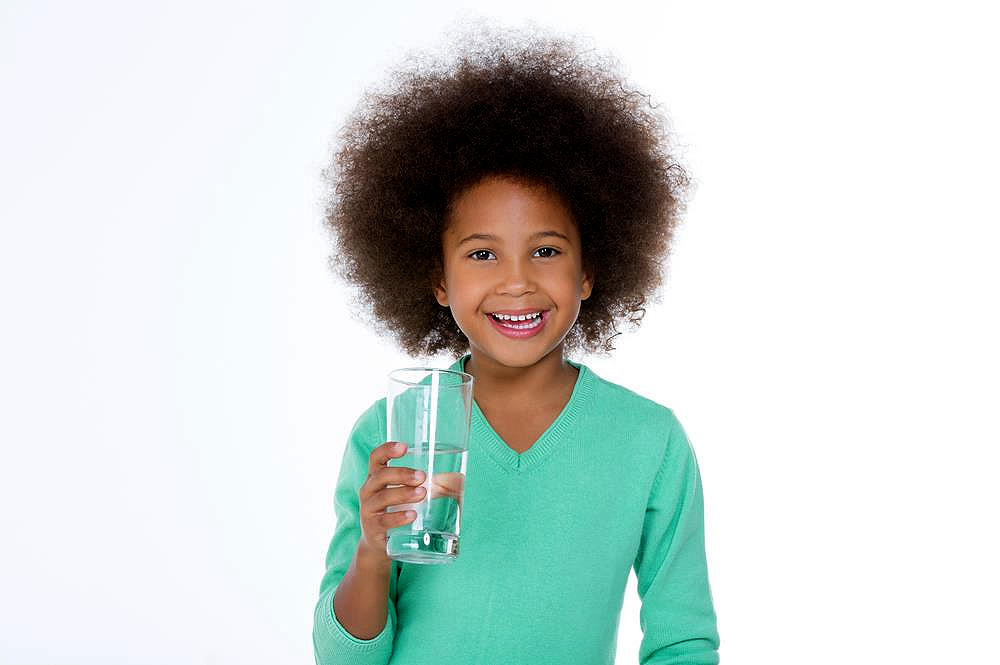 Young boy holding a glass of water